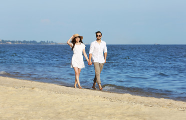 Young couple walking on beach