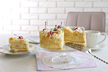 Peace of tasty Butter cake on plate, on color wooden background