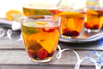 Fruity punch in glassware on metal tray, closeup