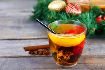 Sangria in bowl and glass with Christmas decoration on wooden table close up