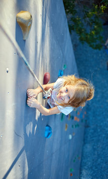 Little girl in  rock climbing gym