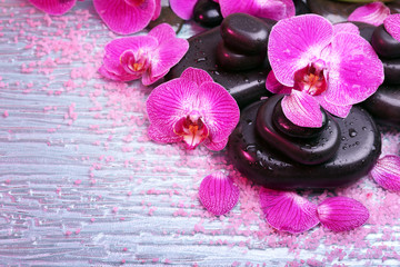 Fototapeta na wymiar Violet orchid and zen stones close-up