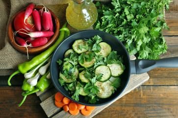 Sliced zucchini in pan on table, top view