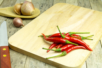 red chilli on wooden cutting board