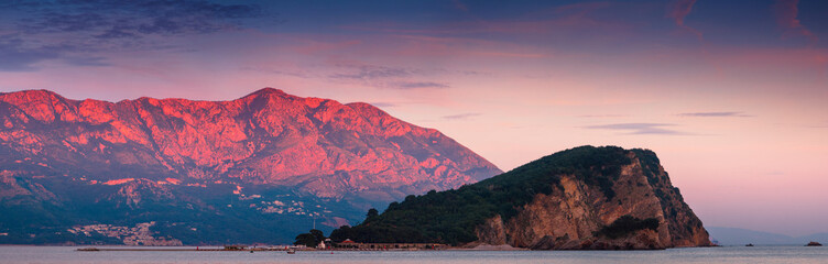 Panoramic view of Sveti Nikola island at sunset.Red mountains. Budva. Montenegro.