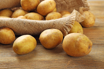 Young potatoes on wooden table close up