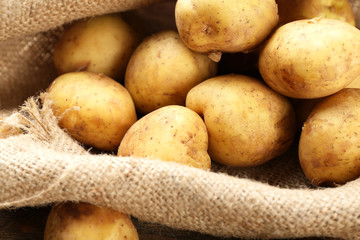 Young potatoes on sackcloth close up