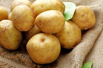 Young potatoes on sackcloth close up