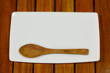 Plate and wood spoon