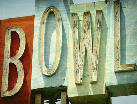 aged and worn vintage photo of neon bowl sign 