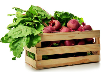 Young beets with leaves in crate isolated on white