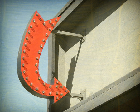 Aged And Worn Vintage Photo Of Neon Arrow Sign