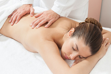 Fototapeta na wymiar Woman getting a massage on her shoulders