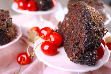 Delicious chocolate roll in saucer on wooden table with napkin, closeup