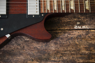 half electric guitar on a wooden background
