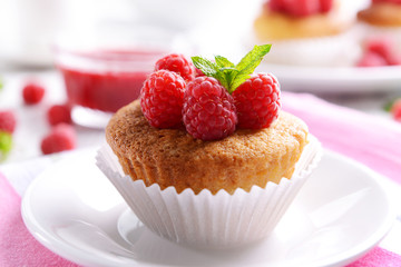 Delicious cupcake with berries and fresh mint on table close up