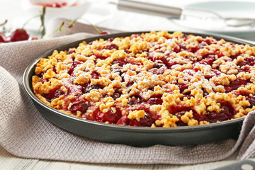 Tasty homemade pie with cherries on table close up
