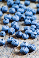 Fresh blueberries on old wooden background selective focus