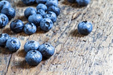 Fresh blueberries on old wooden background selective focus