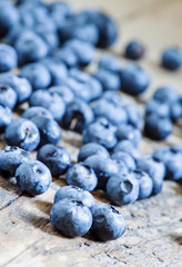 Fresh blueberries on old wooden background selective focus