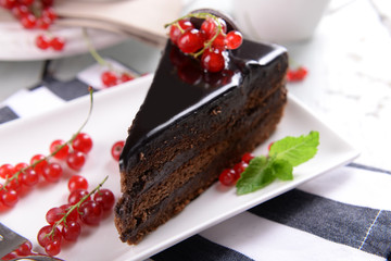 Tasty chocolate cake with berries on table close up