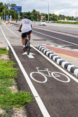 A man have an exercise by riding bicycle focus on symbol
