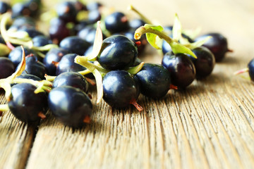 Pile of black currants on wooden table, closeup