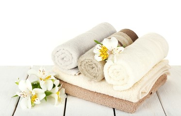 Fototapeta na wymiar Soft towels with flowers isolated on white