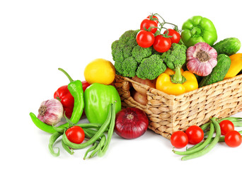 Fototapeta na wymiar Heap of fresh fruits and vegetables in basket isolated on white
