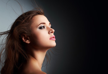 Beautiful makeup woman profile with long hair looking up with ho
