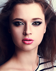 Fototapeta premium Beautiful makeup woman with pink lipstick and smoky eyes make-up