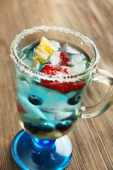 Glass of berries juice on wooden table, closeup