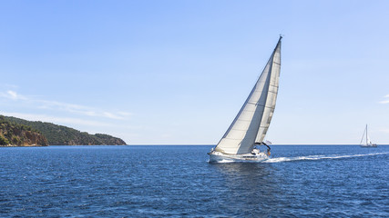 Sailing. Ship yachts with white sails in the Sea. Luxury boats.