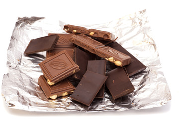 Broken Chocolate bar in foil isolated on white background