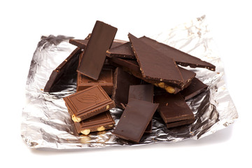 Broken Chocolate bar in foil isolated on white background