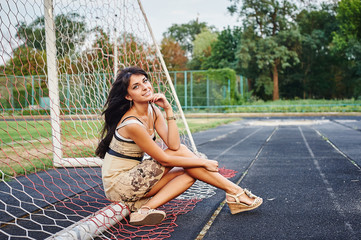 Beautiful young woman on the football field