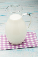 a jug of milk on wooden table