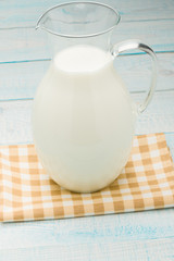 jug of milk on a yellow checkered tablecloth