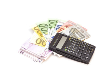 Calculator with euro bank notes isolated on white