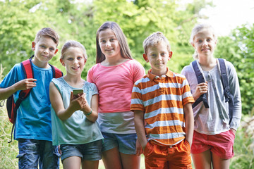 Group Of Children Geocaching In Woods
