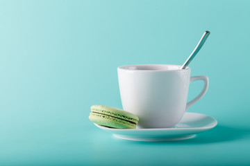 Coffee cup on aqua background with place for an inscription