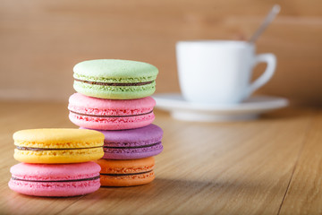 Six colorfull french macaron and cup