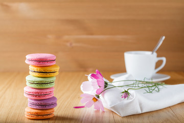 Six colorful french macaron and cup