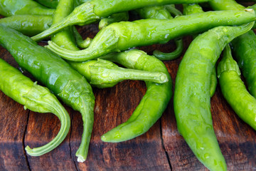 Fresh green italian bell pepper friggitelli on wooden background