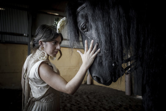 Bailaora de flamenco con caballo negro &Aacute;rabe. Gitana flamenca y su caballo negro &Aacute;rabe. Espect&aacute;culo de baile flamenco con caballos.