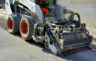 Milling of asphalt for road reconstruction accessory for skid steer