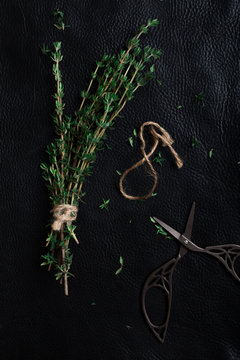 sprigs of thyme dismantled on a black