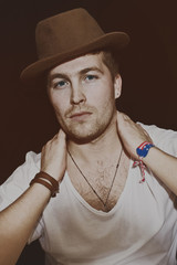 Fototapeta na wymiar Portrait of young man wearing hat