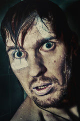 Portrait of a wet man with crazy eyes - obrazy, fototapety, plakaty