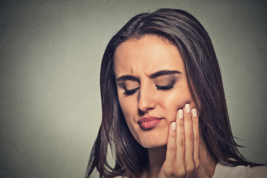 woman with sensitive toothache crown problem